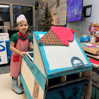 young boy showcasing his ice cream truck project